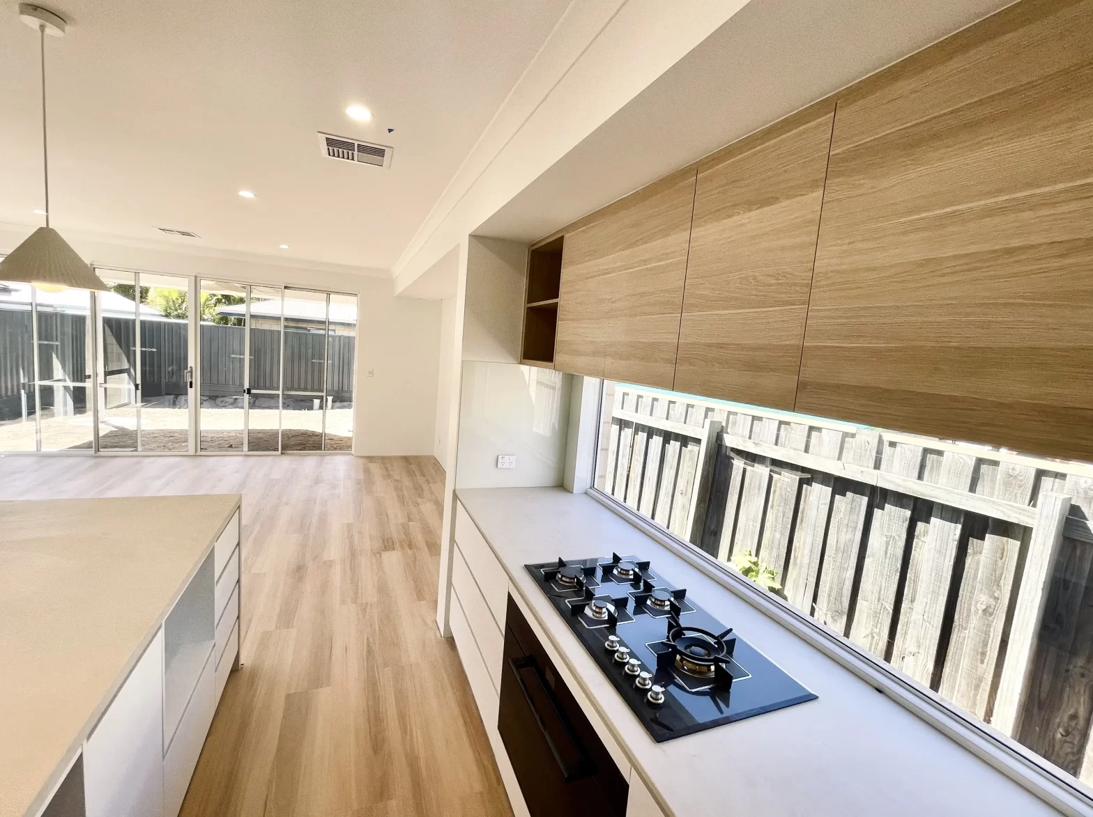 An entertainer’s kitchen, featuring a statement stone island bench, a discreet scullery, and integrated high-performance appliances.